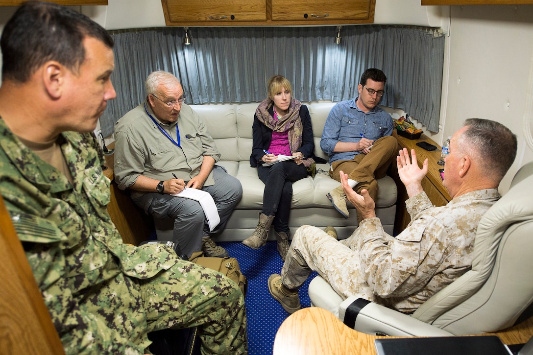 Navy Capt. Gregory Hicks, left, special assistant to the chairman for Public Affairs, listens in as Marine Corps Gen. Joe Dunford, chairman of the Joint Chiefs of Staff, conducts an interview with Jim Garamone of DoD News, second left, Missy Ryan of the Washington Post, center, and Bill Hennigan of the L.A. Times, aboard a C-17 aircraft, April 22, 2016. Dunford visited Iraq to assess the campaign against the Islamic State of Iraq and the Levant. DoD photo by Navy Petty Officer 2nd Class Dominique A. Pineiro