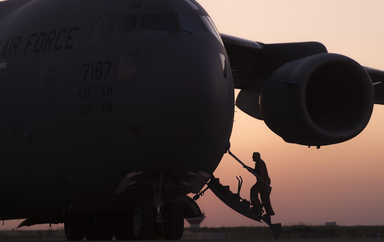 An Air Force crew chief boards the C-17 Globemaster III that will transport Marine Corps Gen. Joe Dunford, chairman of the Joint Chiefs of Staff, on his departure from Irbil, Iraq, April 22, 2016. Dunford visited Iraq to assess the campaign against the Islamic State of Iraq and the Levant. DoD photo by Navy Petty Officer 2nd Class Dominique A. Pineiro