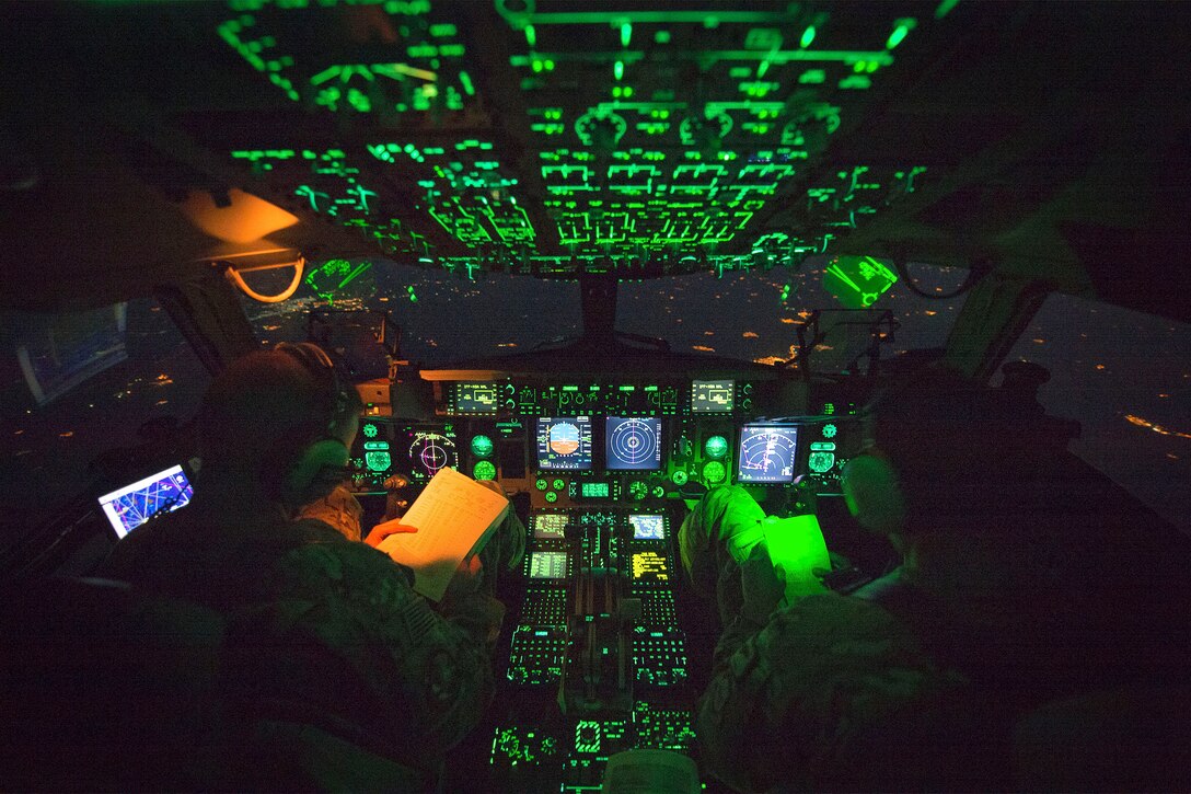 Air Force Capt. Mike Elliott, aircraft commander, and Air Force Capt. Addison Schenk, copilot, monitor the controls of a C-17 transporting Marine Corps Gen. Joe Dunford, chairman of the Joint Chiefs of Staff, from Iraq’s Kurdistan region,  April 22, 2016. Dunford visited Iraq to assess the campaign against the Islamic State of Iraq and the Levant. DoD photo by Navy Petty Officer 2nd Class Dominique A. Pineiro