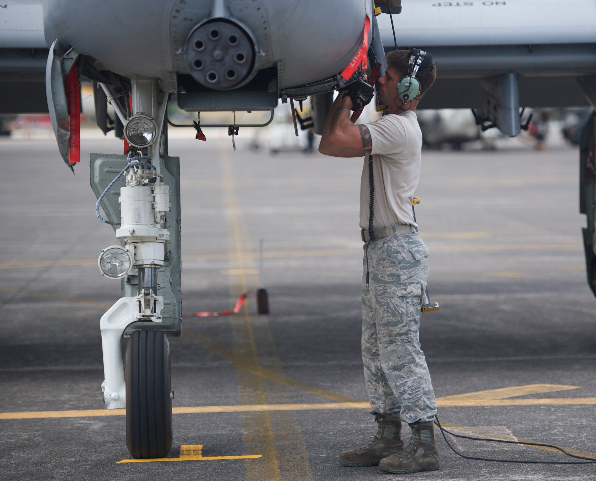 U.S. Air Force Senior Airman Jonathan Simmons, a weapons load crew member deployed from Osan Air Base, Republic of Korea, inspects an A-10C Thunderbolt II prior to the aircraft’s takeoff April 21, 2016, at Clark Air Base, Philippines. The aircraft and Airmen are deployed in support of the first iteration of U.S. Pacific Command’s Air Contingent, designed to promote interoperability and provide greater and more transparent air and maritime situational awareness to ensure safety for military and civilian activities in international waters. (U.S. Air Force photo by Capt. Susan Harrington)