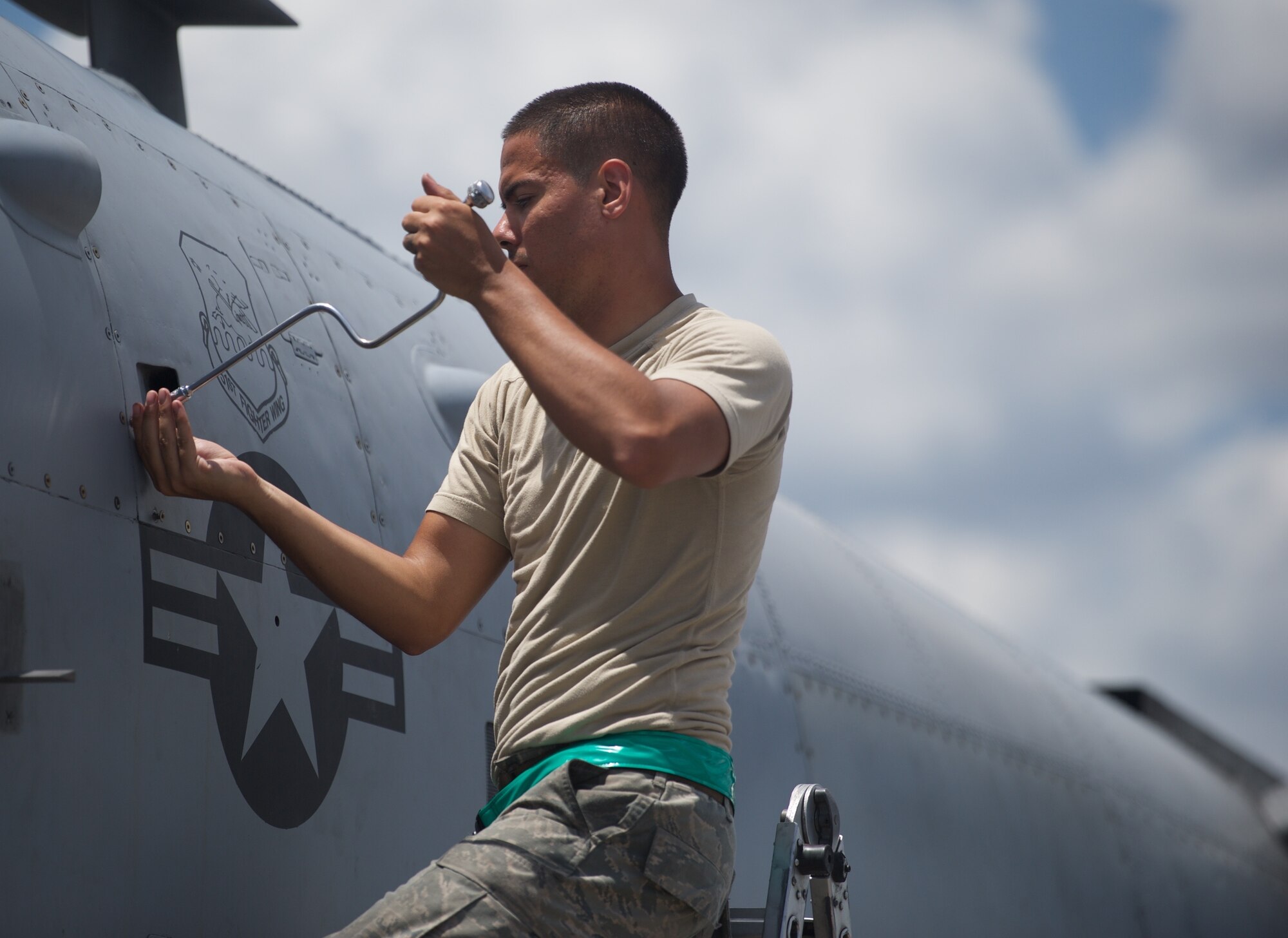 U.S. Air Force Staff Sgt. Eric Rister, an avionics technician deployed from Osan Air Base, Republic of Korea, unscrews a panel on an A-10C Thunderbolt II after the aircraft completed a mission flying in the vicinity of Scarborough Shoal April 21, 2016. The aircraft can be serviced and operated from bases with varied facilities, additionally; many of its parts are interchangeable left and right, including the engines, main landing gear and vertical stabilizers. These unique aspects of the aircraft allow the aircrew and maintainers to deploy with minimal equipment and still ensure the jets are ready to fly missions out of Clark AB at a moment’s notice, exercising the rights of freedom of navigation in international waters and international airspace. (U.S. Air Force photo by Capt. Susan Harrington)
