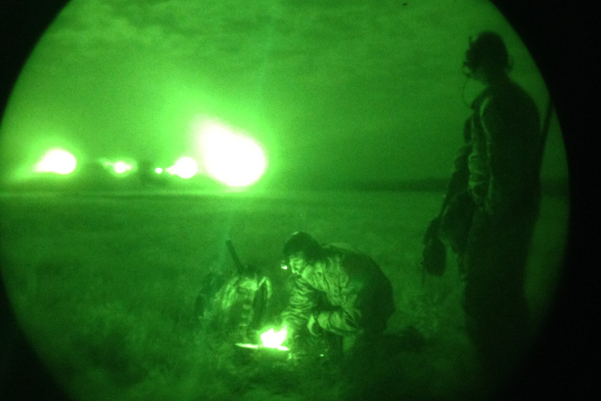 From Left: Air Force Capt. Luke Berreckman, an air mobility liaison officer assigned to the 621st Contingency Operations Support Group, McGuire Air Force Base, N.J., and attached to 3rd Infantry Division, and Army Sgt. Tyler Negri, an infantryman with 1st Battalion, 30th Infantry Regiment, 4th Infantry Brigade Combat Team, 3rd Infantry Division, communicate with a C-130 Hercules aircraft as it lands on the Fort Stewart, Ga., Remagen drop zone during a joint airborne and air transportability training event, May 2, 2015. (U.S. Army Photo by Sgt. Bob Yarbrough, 4th IBCT, 3rd ID, Public Affairs)