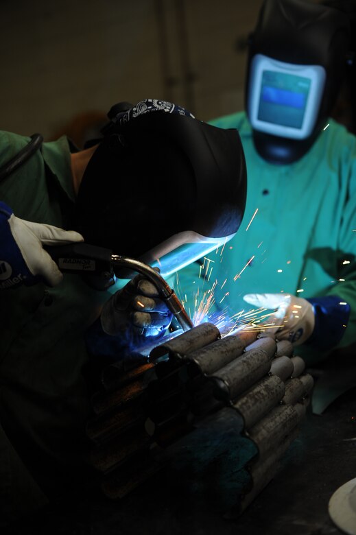 Staff Sgt. Corina Waxenfelter, 22nd Civil Engineer Squadron structures craftsman, welds the base of a sculpture during the 2016 Welding Competition, April 20, 2016, at McConnell Air Force Base, Kan. The event featured three different welding skill tasks and a creative construction portion with a 60th Anniversary KC-135 Stratotanker theme. (U.S. Air Force photo/Airman Jenna K. Caldwell)   