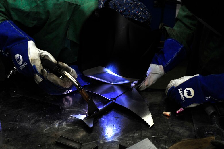 Staff Sgt. Corina Waxenfelter, 22nd Civil Engineer Squadron structures craftsman, prepares to weld a KC-135 Stratotanker model during the 2016 Welding Competition, April 20, 2016, at McConnell Air Force Base, Kan. The theme of this portion of the competition was the 60th Anniversary of the KC-135. (U.S. Air Force photo/Airman Jenna K. Caldwell)   