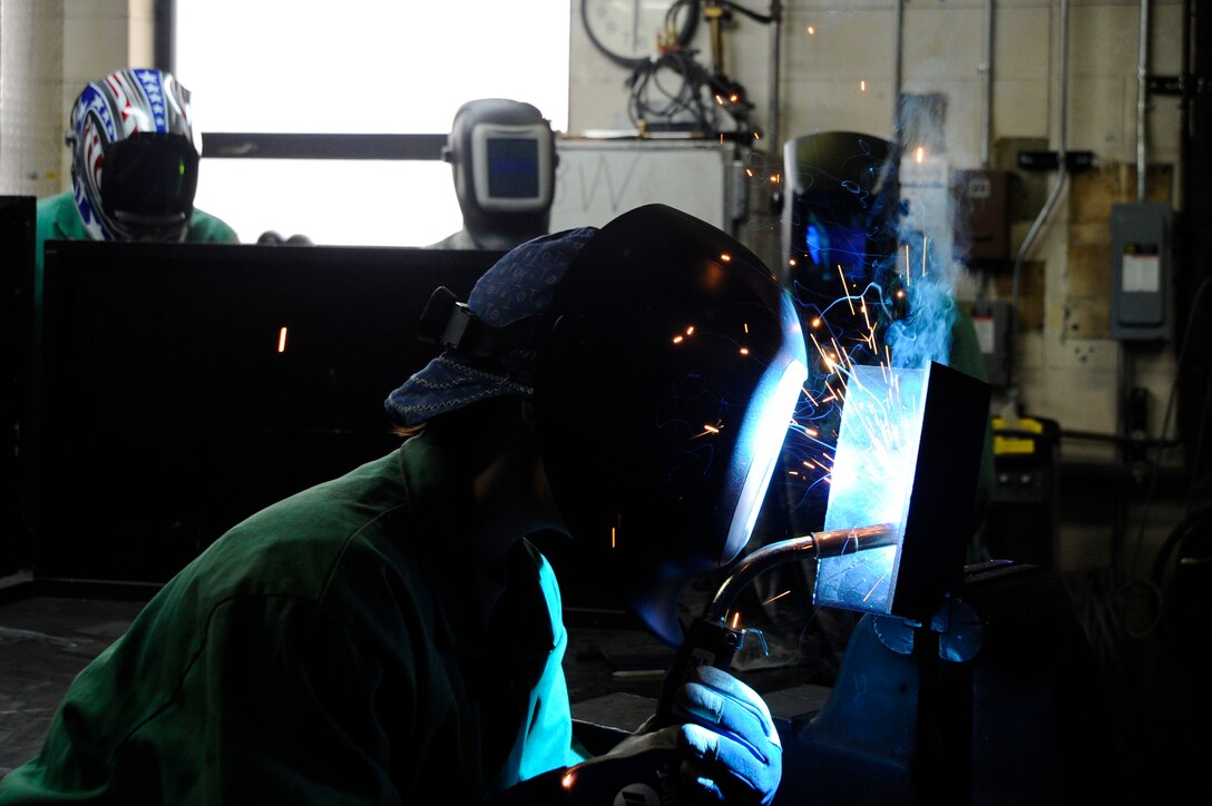 Staff Sgt. Corina Waxenfelter, 22nd Civil Engineer Squadron structures craftsman, creates a vertical t weld during the 2016 Welding Competition, April 20, 2016, at McConnell Air Force Base, Kan. Competitors were each given an opportunity to familiarize themselves with each squadron’s welder before the competition began, so participants aren’t given an unfair advantage. (U.S. Air Force photo/Airman Jenna K. Caldwell)   