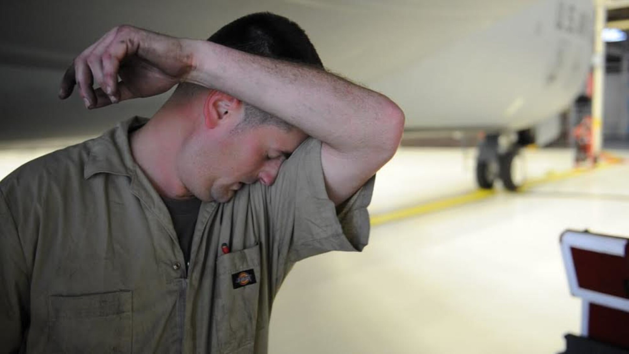 Staff Sgt. Wesley Cress, 92nd Maintenance Squadron isochronal floor supervisor, wipes sweat off his forehead during the bases first KC-135 Stratotanker tire changing competition April 22, 2016, at Fairchild Air Force Base, Wash. Cress worked alongside three other Airmen in the competition in an attempt to bring home victory. (U.S. Air Force photo/Tech. Sgt. Jason Bailey)