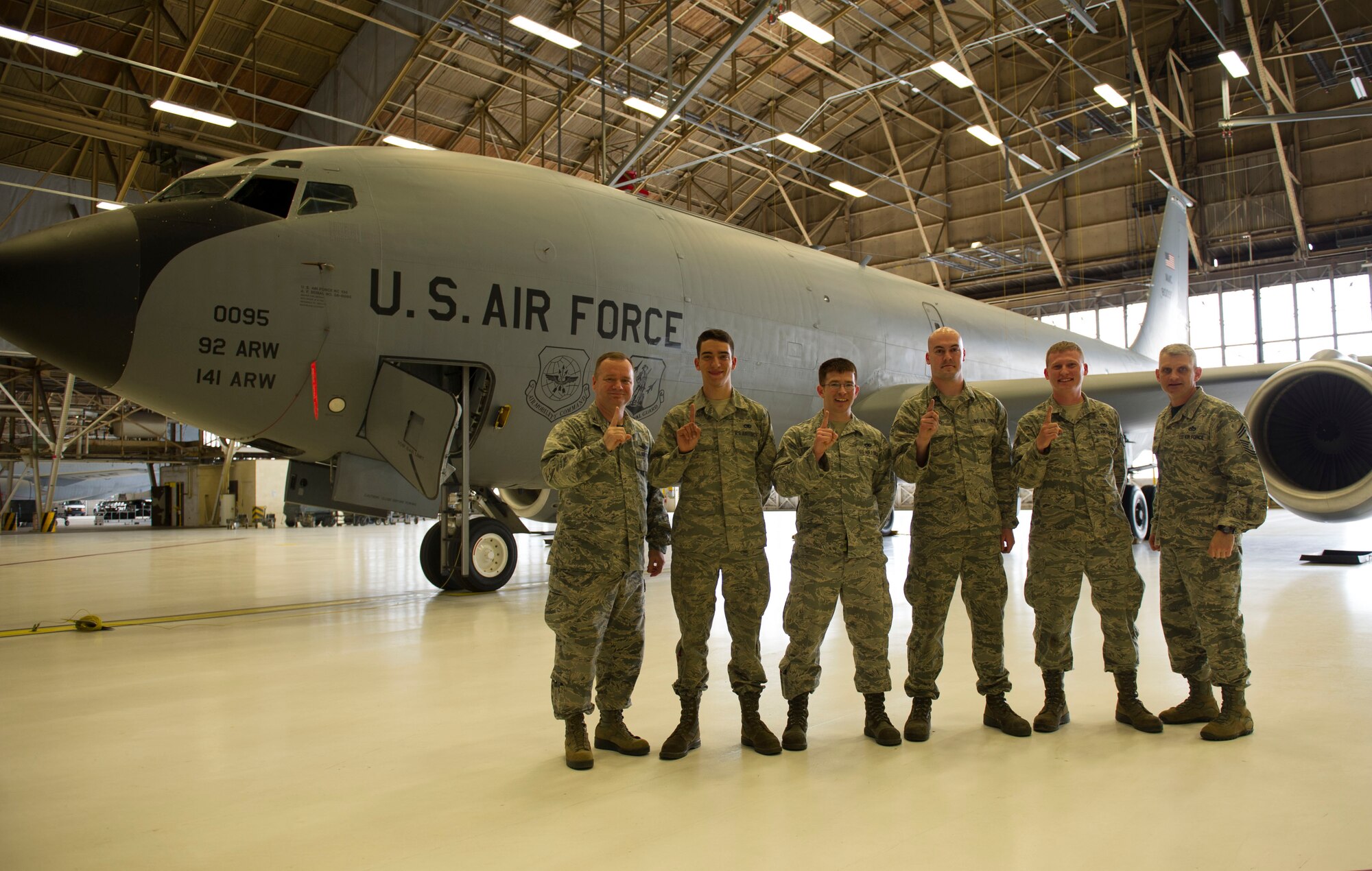 Col. Brian McDaniel (left), 92nd Air Refueling Wing commander, and Chief Master Sgt. Christian Pugh (right), 92nd ARW command chief, pose with the winners of the first 92nd Maintenance Group KC-135 Stratotanker tire changing competition April 22, 2016, at Fairchild Air Force Base, Wash. The winners hail from the 92nd Maintenance Squadron and won with a time of 1:22.46 (1 hour, 22 minutes, 46 seconds) vs. a standard 3 hour ticket time. (U.S. Air Force photo/Airman 1st Class Nick J. Daniello)
