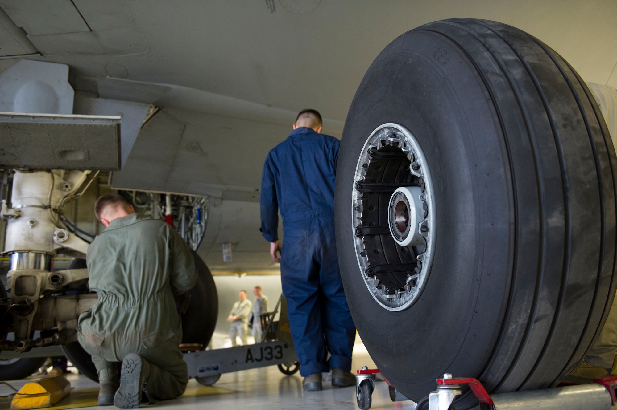 Airmen from the 92nd Maintenance Squadron change a KC-135 Stratotanker tire during the bases first tire changing competition April 22, 2016, at Fairchild Air Force Base, Wash. Airmen raced against the clock for the fastest time. (U.S. Air Force photo/Airman 1st Class Nick J. Daniello)