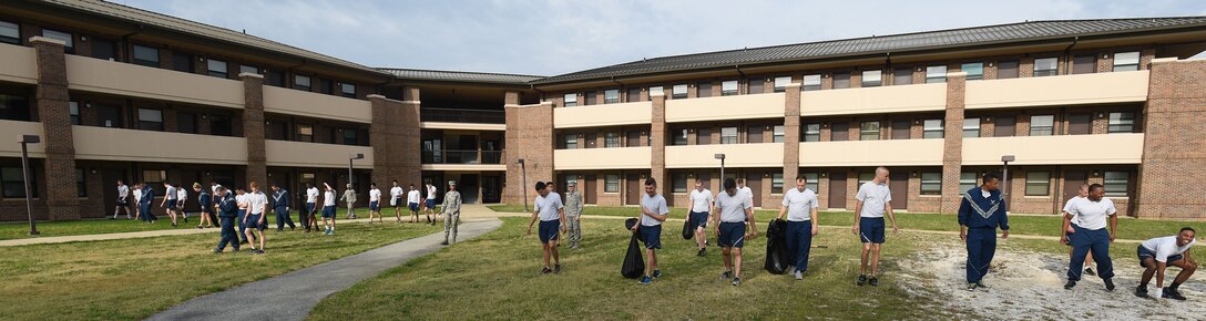 Team Andrews Airmen pick up trash and weeds around their dorm building at Joint Base Andrews, Md., April 22, 2016. Team Andrews cleaned up around base in commemoration of Earth Day. (U.S. Air Force photo by Senior Airman Joshua R. M. Dewberry/RELEASED)