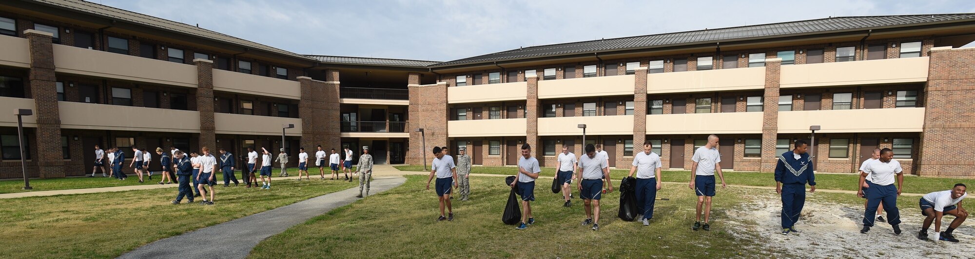 Team Andrews Airmen pick up trash and weeds around their dorm building at Joint Base Andrews, Md., April 22, 2016. Team Andrews cleaned up around base in commemoration of Earth Day. (U.S. Air Force photo by Senior Airman Joshua R. M. Dewberry/RELEASED)