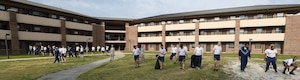 Team Andrews Airmen pick up trash and weeds around their dorm building at Joint Base Andrews, Md., April 22, 2016. Team Andrews cleaned up around base in commemoration of Earth Day. (U.S. Air Force photo by Senior Airman Joshua R. M. Dewberry/RELEASED)