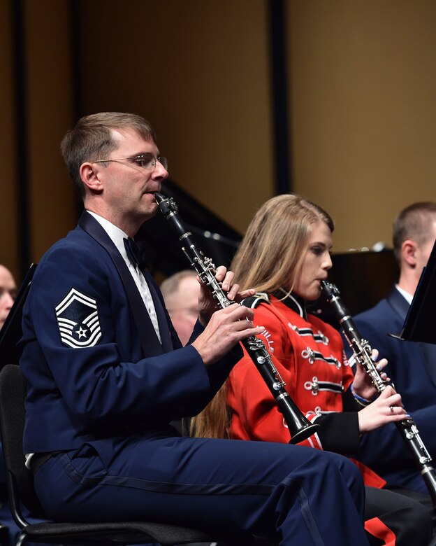 Senior Master Sgt. Brian G. McCurdy, U.S. Air Force Concert Band clarinetist, performs alongside a Russellville High School band member during a Concert Band and Singing Sergeants performance at Russellville High School, in Russellville, Ark., April 5, 2016. The band worked with roughly 1,000 students from 14 schools across five states on the tour as part of the Advancing Innovation through Music program.  (U.S. Air Force photo by Senior Airman Dylan Nuckolls/Released)