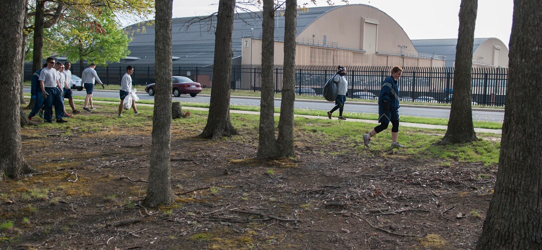 744th Communications Squadron Airmen pick up trash on Joint Base Andrews, Md., April 22, 2016. The Airmen assisted with the base-wide clean up in commemoration of Earth Day. (U.S. Air Force photo by Airman Gabrielle Spalding/Released)