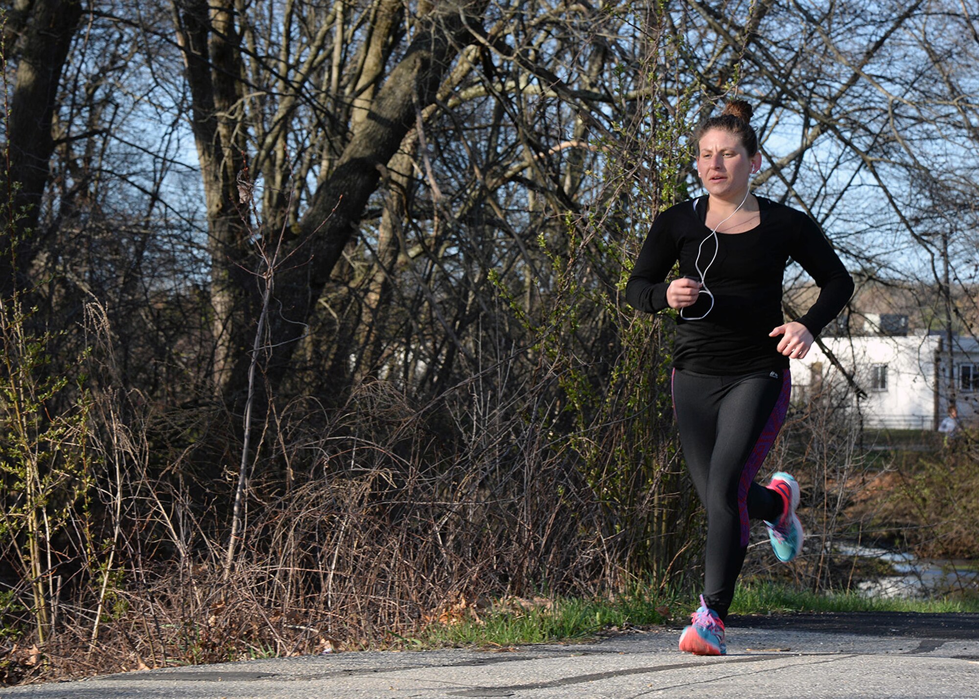 Adena D'Avolio, 66th Force Support Squadron illustrator, runs through Castle Park during the Bunny Hop 5K April 20. In the men’s category, Gerry Cavallo placed first with a time of 20:22. Finishing second was Paul Landrey in 22:27, and Andy Deardorf placed third with a time of 24:43. In the women’s category D'Avolio placed first in 24:38 while Lisa Kelly and Katy Murray ran for 25:30. (U.S. Air Force photo by Linda LaBonte Britt)