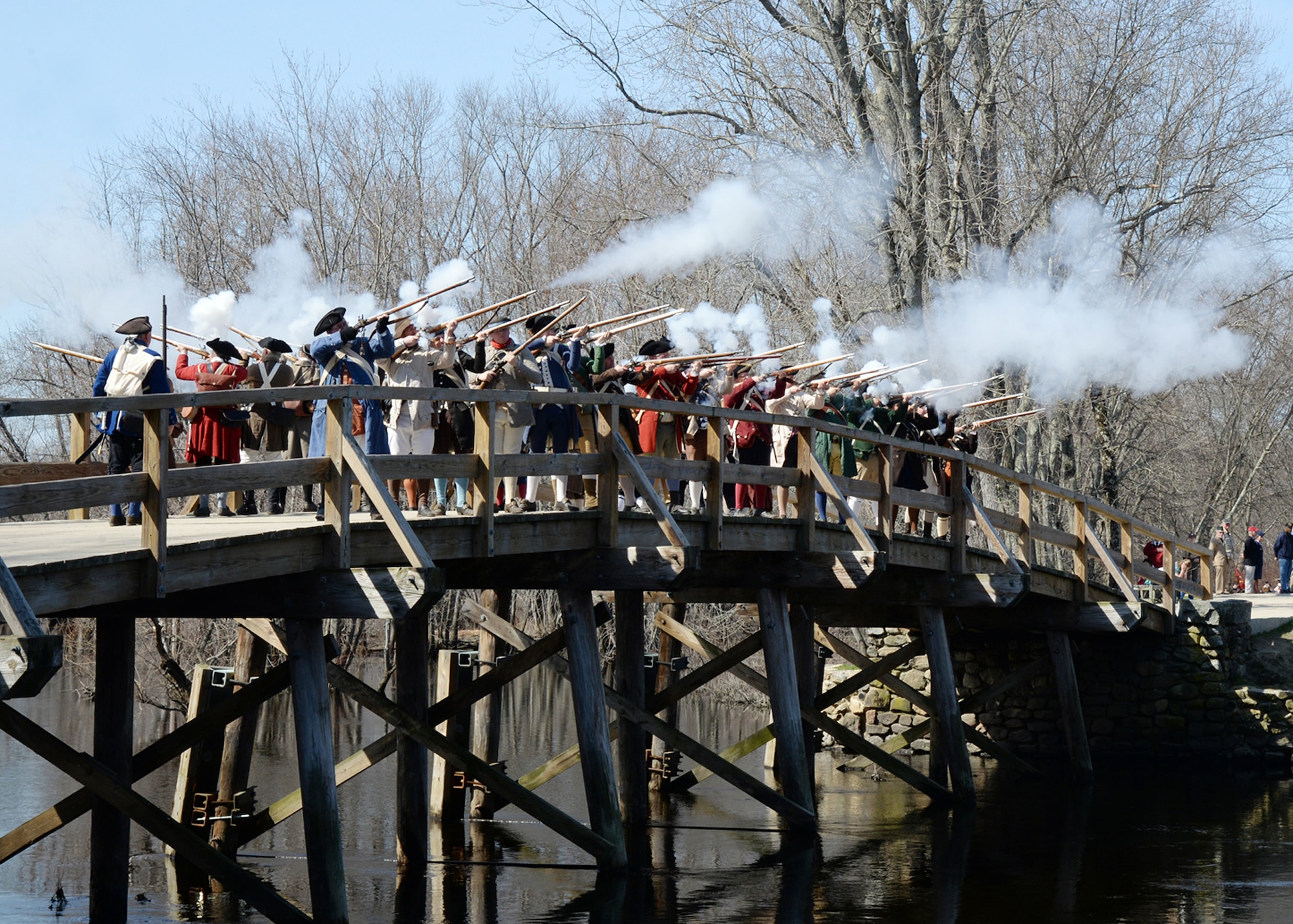 Colonial reenactors commemorate the Shot heard round the world with a staging of the North Bridge fight April 18 in Concord, Mass. Each year in mid-April, thousands of people flock to historic Lexington and Concord and Minute Man National Historical Park to celebrate Patriots' Day. Patriots' Day is a special Massachusetts State holiday commemorating the opening battle of the American Revolutionary War, April 19, 1775. (U.S. Air Force photo by Linda LaBonte Britt)