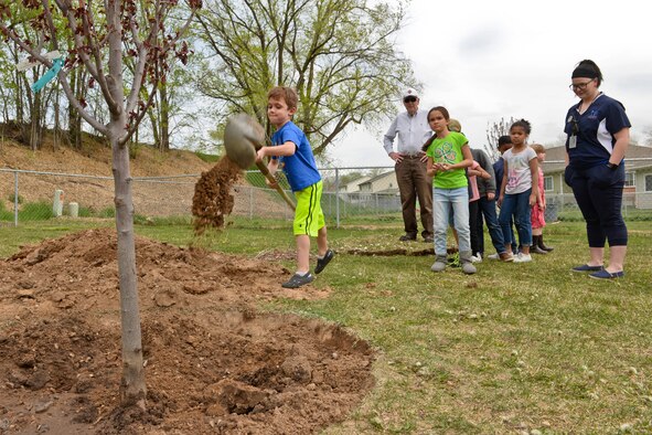 Children from the Hill Force Base Youth Center plant a flowering plum tree April 22 in the base housing area. The base planted four trees in the housing area in conjunction with Earth Day.  Earth Day, which takes place annually on April 22, serves as a day to demonstrate support for environmental protection. The Air Force's overarching Earth Day theme continues to be Conserve Today. Secure Tomorrow. (U.S. Air Force photo by Paul Holcomb) 