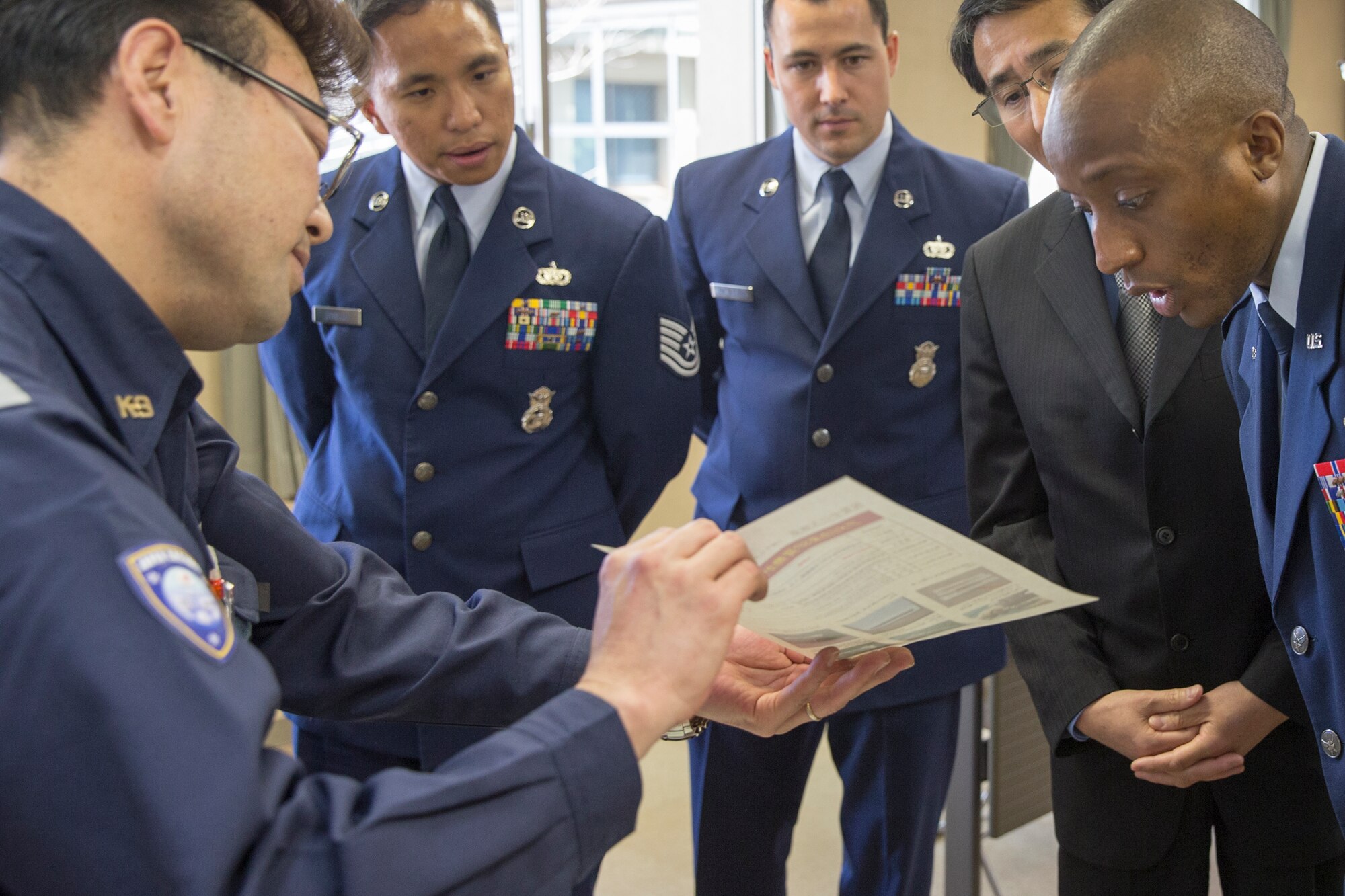 Satoru Takiguchi, left, Tokyo Customs Canine Training Center supervisor, introduces Tokyo Customs operations to members from the 374th Security Forces Squadron at Tokyo Customs Canine Training Center, Chiba prefecture, Japan, April 15, 2016. Yokota SFS members visited the training center for the first time in history. (U.S. Air Force photo by Yasuo Osakabe/Released)