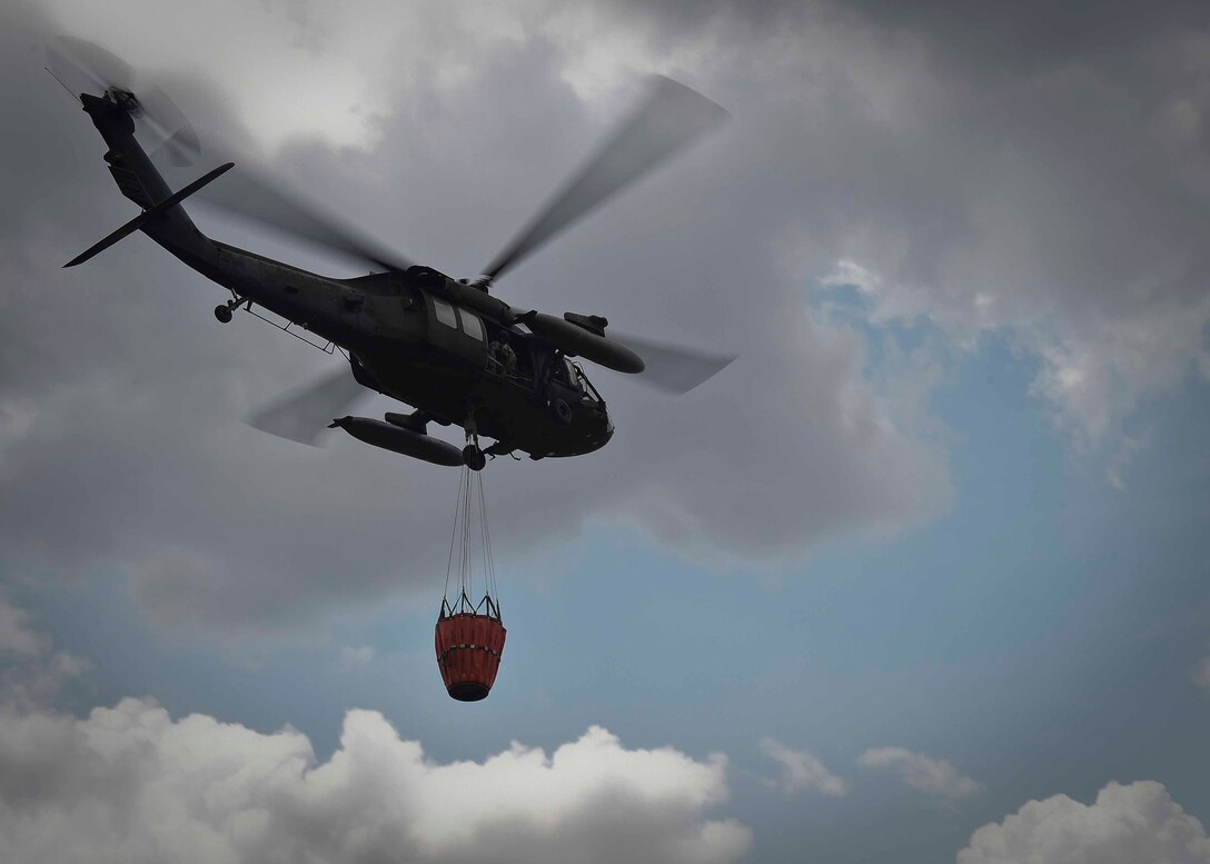 A UH-60 Black Hawk helicopter assigned to the 1st Battalion, 228th Aviation Regiment, Joint Task Force Bravo at Soto Cano Air Base, Honduras, carries a Bambi Bucket holding 700 gallons of water during a firefighting mission in the Darién province of Panama, April 17, 2016. The Bambi Bucket-equipped Black Hawk was ideal for this operation because of its ability to access areas unreachable by land firefighting crews and the volume of water each aircraft’s Bambi Bucket can drop on a single pass. (U.S. Air Force photo by Staff Sgt. Siuta B. Ika)