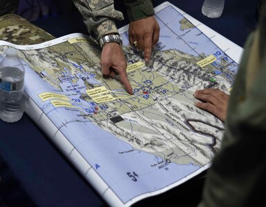 Members of the Panamanian Public Forces and the 1st Battalion, 228th Aviation Regiment, a unit assigned to Joint Task Force Bravo at Soto Cano Air Base, Honduras, discuss operational details before fighting wildfires in the Darién province of Panama, April 17, 2016. The real-world operation provided an opportunity for U.S. and Panamanian forces to work closely together outside of a training environment, such as CENTAM SMOKE, or Sharing Mutual Operational Knowledge and Experiences, a semi-annual firefighting exercise hosted at Soto Cano AB. (U.S. Air Force photo by Staff Sgt. Siuta B. Ika)