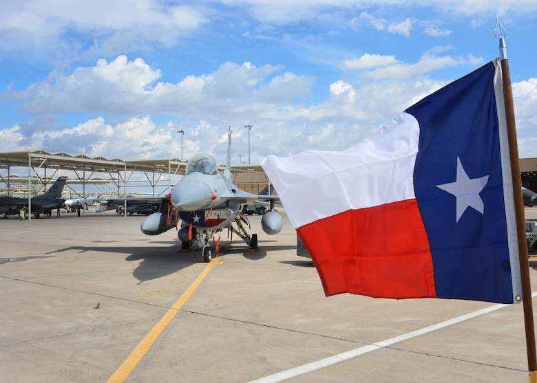 A Texas flag is displayed near an F-16 Fighting Falcon at Luke Air Force Base, Arizona, April 8, 2016. The F-16 is assigned to the Texas Air National Guard’s 149th Fighter Wing, headquartered at Joint Base San Antonio-Lackland, Texas, which is currently operating at Luke while San Antonio’s Kelly Field undergoes runway repairs. The flag was displayed during the loading portion of the 56th Fighter Wing’s quarterly load crew of the quarter competition. (U.S. Air National Guard photo by 2nd Lt. Phil Fountain)