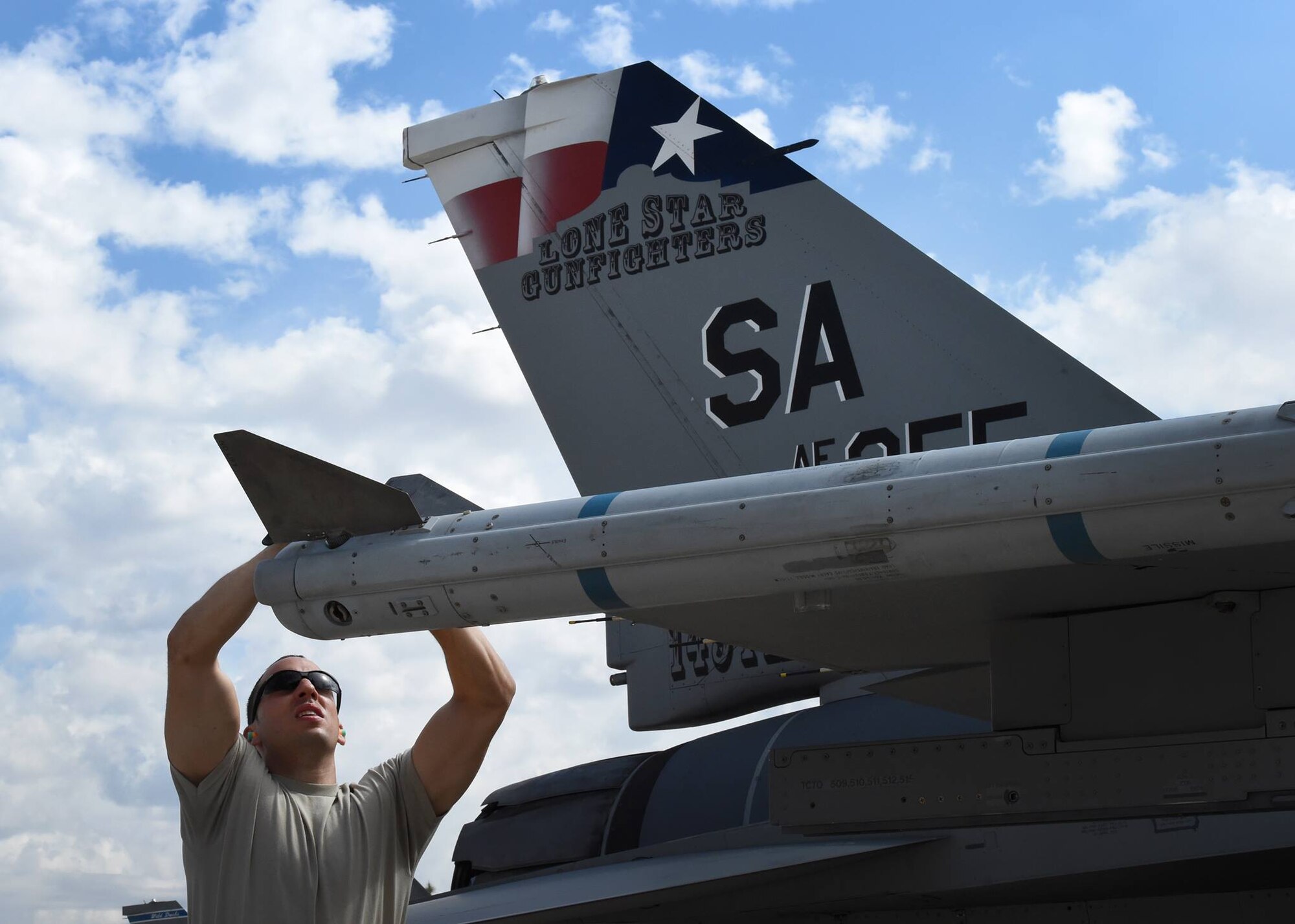 Tech. Sgt. Federico Barrios, an aircraft armament systems technician, installs a fin on an inert AIM-120, advanced medium-range air-to-air missile during the loading portion of the 56th Fighter Wing’s quarterly load crew of the quarter competition at Luke Air Force Base, Arizona, April 8, 2016. Barrios is a member of the Texas Air National Guard’s 149th Fighter Wing, headquartered at Joint Base San Antonio-Lackland, Texas, which is currently operating at Luke while San Antonio’s Kelly Field undergoes runway repairs. (U.S. Air National Guard photo by 2nd Lt. Phil Fountain)