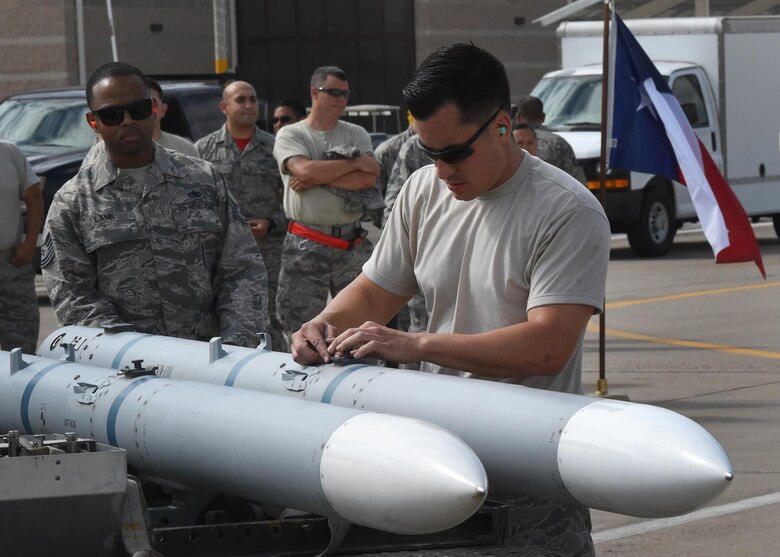 Tech. Sgt. Leroy Lane (left), a weapons standardization loading crew member with the 56th Maintenance Group, evaluates Senior Airman Robert Satter (right), an aircraft armament systems technician, inspect an inert AIM-120, advanced medium-range air-to-air missile, as part of the loading portion of the 56th Fighter Wing’s quarterly load crew of the quarter competition at Luke Air Force Base, Arizona, April 8, 2016. Satter is a member of the Texas Air National Guard’s 149th Fighter Wing, headquartered at Joint Base San Antonio-Lackland, Texas, which is currently operating at Luke while San Antonio’s Kelly Field undergoes runway repairs. (U.S. Air National Guard photo by 2nd Lt. Phil Fountain)