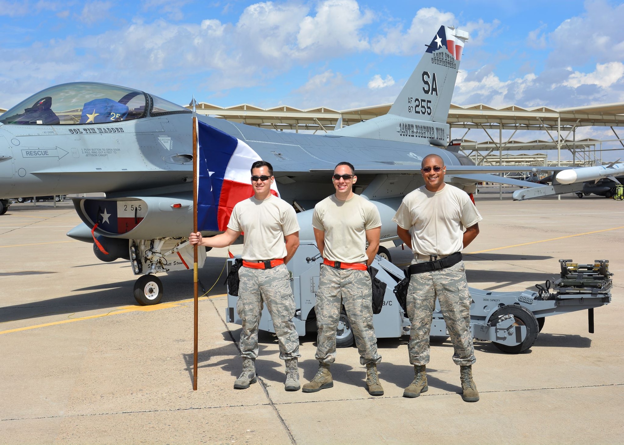 Senior Airman Robert Satter (left), Tech. Sgt. Federico Barrios (center) and Tech. Sgt. Mark Nash (right), aircraft armament systems technicians assigned to the 149th Fighter Wing, Texas Air National Guard, stand in a group following to the loading portion of the 56th Fighter Wing’s quarterly load crew of the quarter competition at Luke Air Force Base, Arizona, April 8, 2016. The competition is a quarterly event that recognizes the top aircraft armament systems technicians operating at Luke. 149th Fighter Wing, headquartered at Joint Base San Antonio-Lackland, Texas, is currently operating at Luke while San Antonio’s Kelly Field undergoes runway repairs. (U.S. Air National Guard photo by 2nd Lt. Phil Fountain)