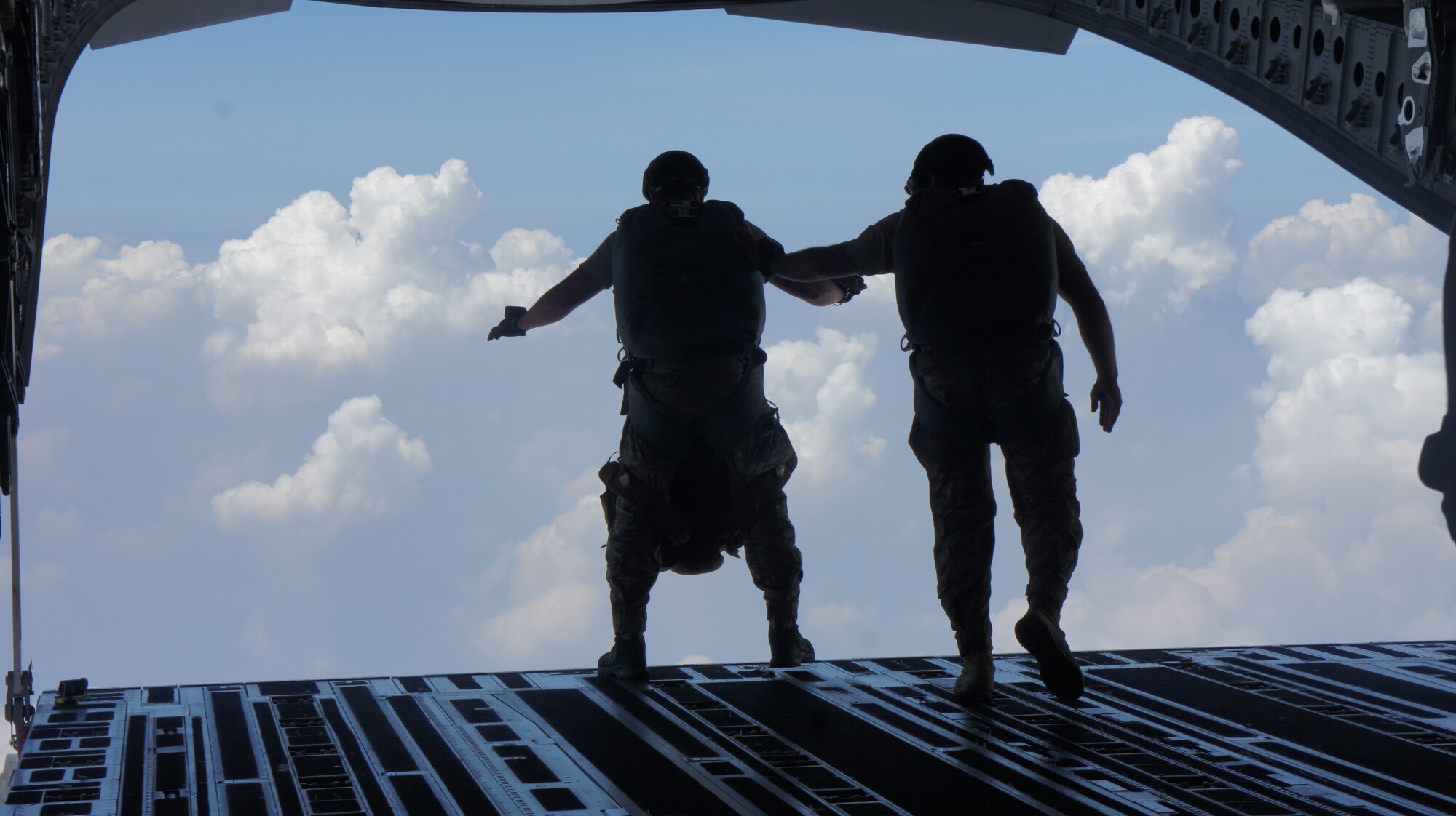 Pararescue jumpers with the 31st Rescue Squadron conduct a High Altitude Low Opening jump out of a a C-17 Globemaster III aircraft crewed by airmen from the 535th and 204th Airlift squadron during Balikatan 2016, Clark Air Field, Philippines, April 15, 2016. Balikatan, which means shoulder to shoulder in Filipino, is an annual bilateral training exercise aimed at improving the ability of Philippine and U.S. military forces to work together during planning, contingency and humanitarian assistance and disaster relief operations. (U.S. Air National Guard photo by Tech. Sgt. Andrew Jackson/released)
