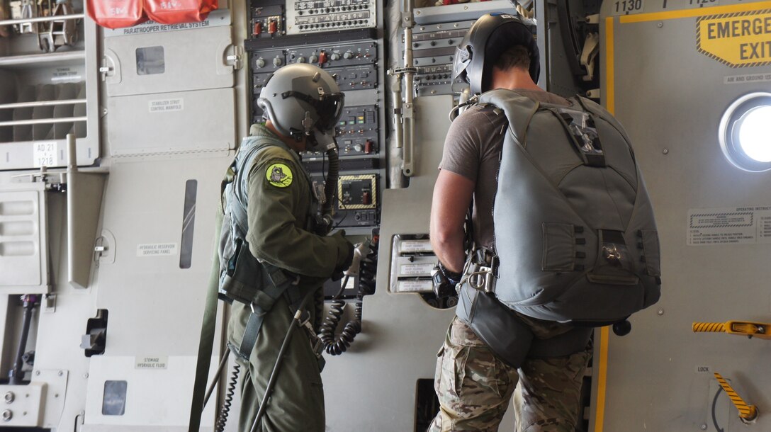 Tech. Sgt. Randy Yamada, loadmaster with the 204th Airlift squadron, Hawaii Air National Guard speaks to a pararescue jumper during a High Altitude Low Opening airdrop mission during Balikatan 2016, Clark Air Field, Philippines, April 15, 2016. Balikatan, which means shoulder to shoulder in Filipino, is an annual bilateral training exercise aimed at improving the ability of Philippine and U.S. military forces to work together during planning, contingency and humanitarian assistance and disaster relief operations. (U.S. Air National Guard photo by Tech. Sgt. Andrew Jackson/released)
