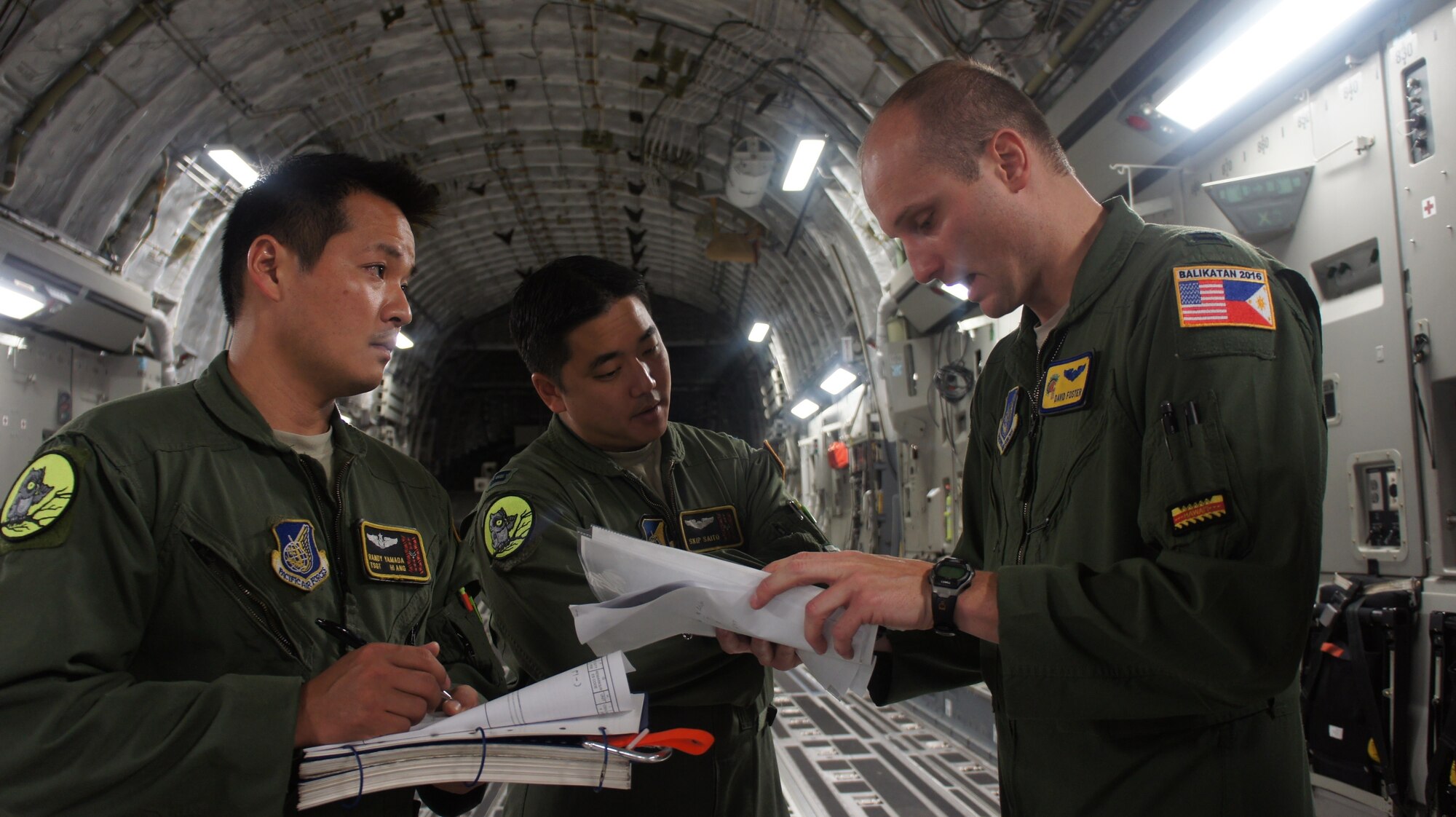 Capt. David Foster, 535th Airlift Squadron briefs air crew members Capt. Skip Saito and Loadmaster, Tech. Sgt. Randy Yamada on the day's air drop mission during Balikatan 2016, Clark Air Field, Philippines, April 15, 2016. Balikatan, which means shoulder to shoulder in Filipino, is an annual bilateral training exercise aimed at improving the ability of Philippine and U.S. military forces to work together during planning, contingency and humanitarian assistance and disaster relief operations. (U.S. Air National Guard photo by Tech. Sgt. Andrew Jackson/released)