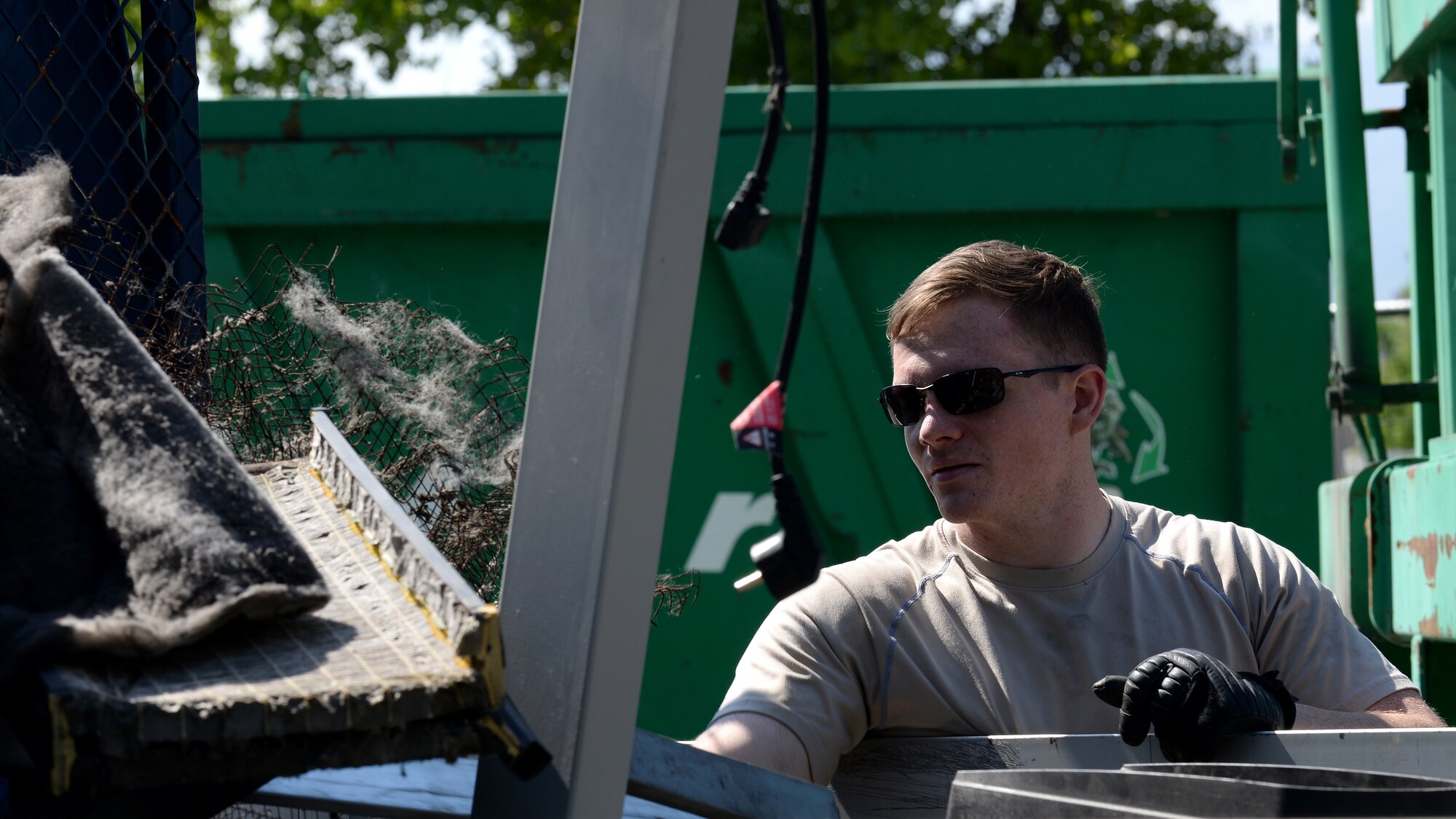 Senior Airman Kyle Jones, 31st Communications Squadron radio frequency transmission technician, disposes of used office equipment during the Defense Logistics Agency spring clean event, April 19-22, 2016, at Aviano Air Base, Italy. The DLA holds the annual event to receive the maximum number of items in the minimum amount of time. (U.S. Air Force photo by Airman 1st Class Cary Smith/Released) 