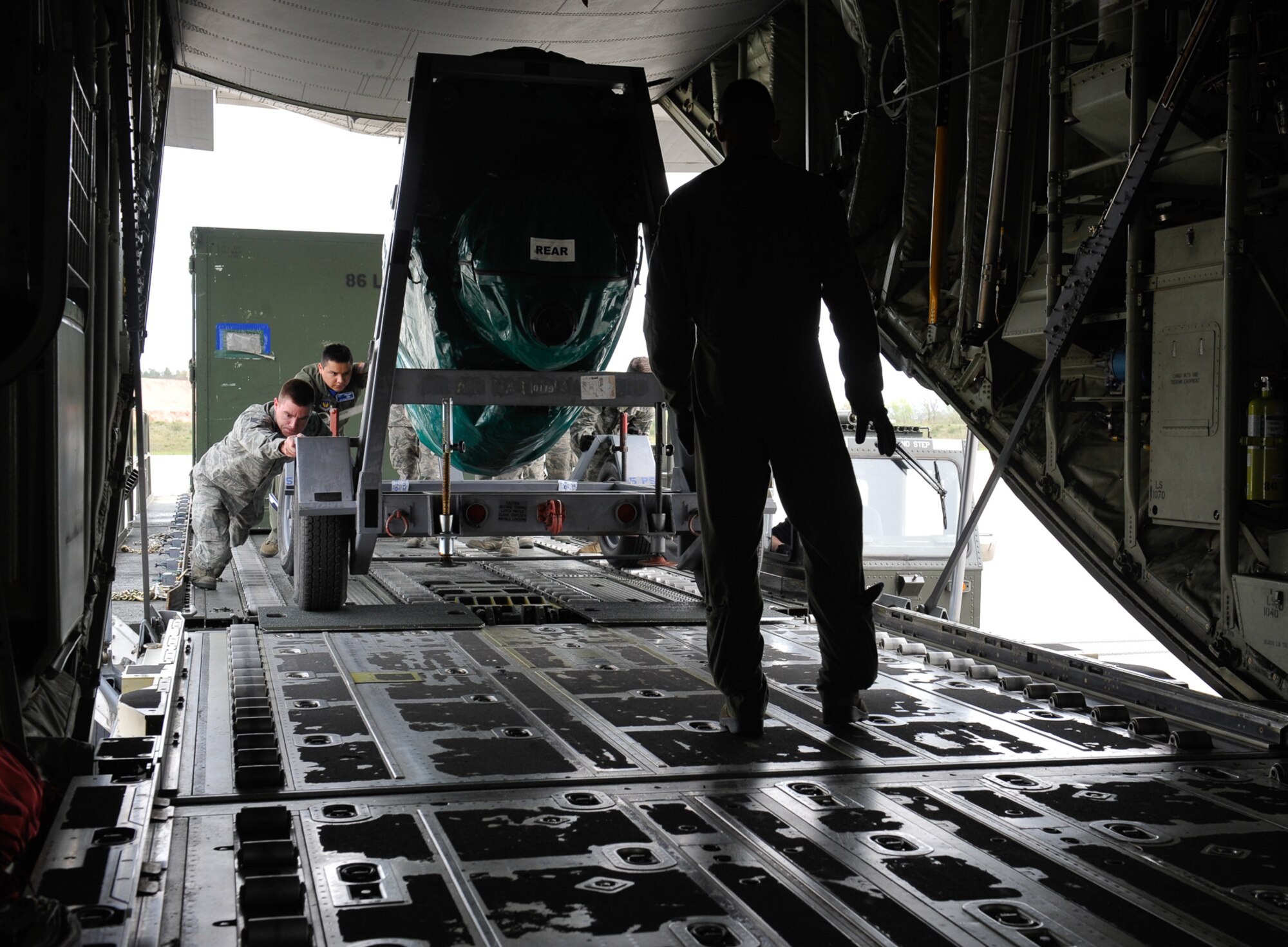 Staff Sgt. Josh Wade, 86th Aircraft Maintenance Squadron crew chief, helps loadmasters from the 37th Airlift Squadron load cargo onto a C-130J Super Hercules during Wing Thunder April 22, 2016, at Ramstein Air Base, Germany. Aircraft maintainers and loadmasters work hand-in-hand to ensure all aircraft cargo and passengers are securely fastened prior to take-off. (U.S. Air Force photo/Staff Sgt. Leslie Keopka)