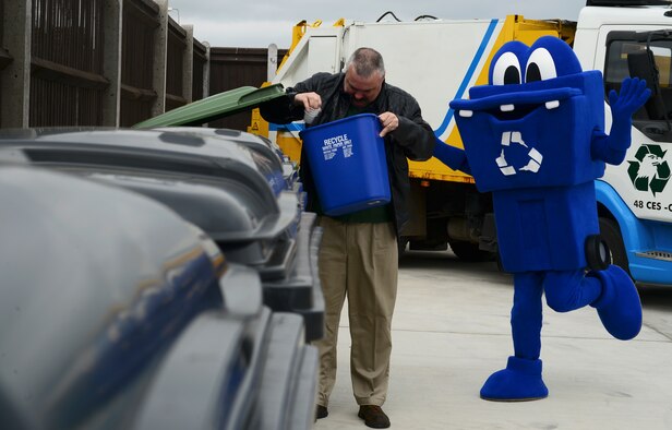 A customer and Chuck-IT, 48th Civil Engineer Squadron recycling center mascot utilize the newly expanded recycling center at Royal Air Force Lakenheath, England, April 22, 2016. The recycling center collects plastic, mixed paper, cardboard, scrap metal and other recyclable materials. Money earned by the facility is returned to the base supporting base morale and recreational projects. (U.S. Air Force photo by Senior Airman Dawn M. Weber/Released)