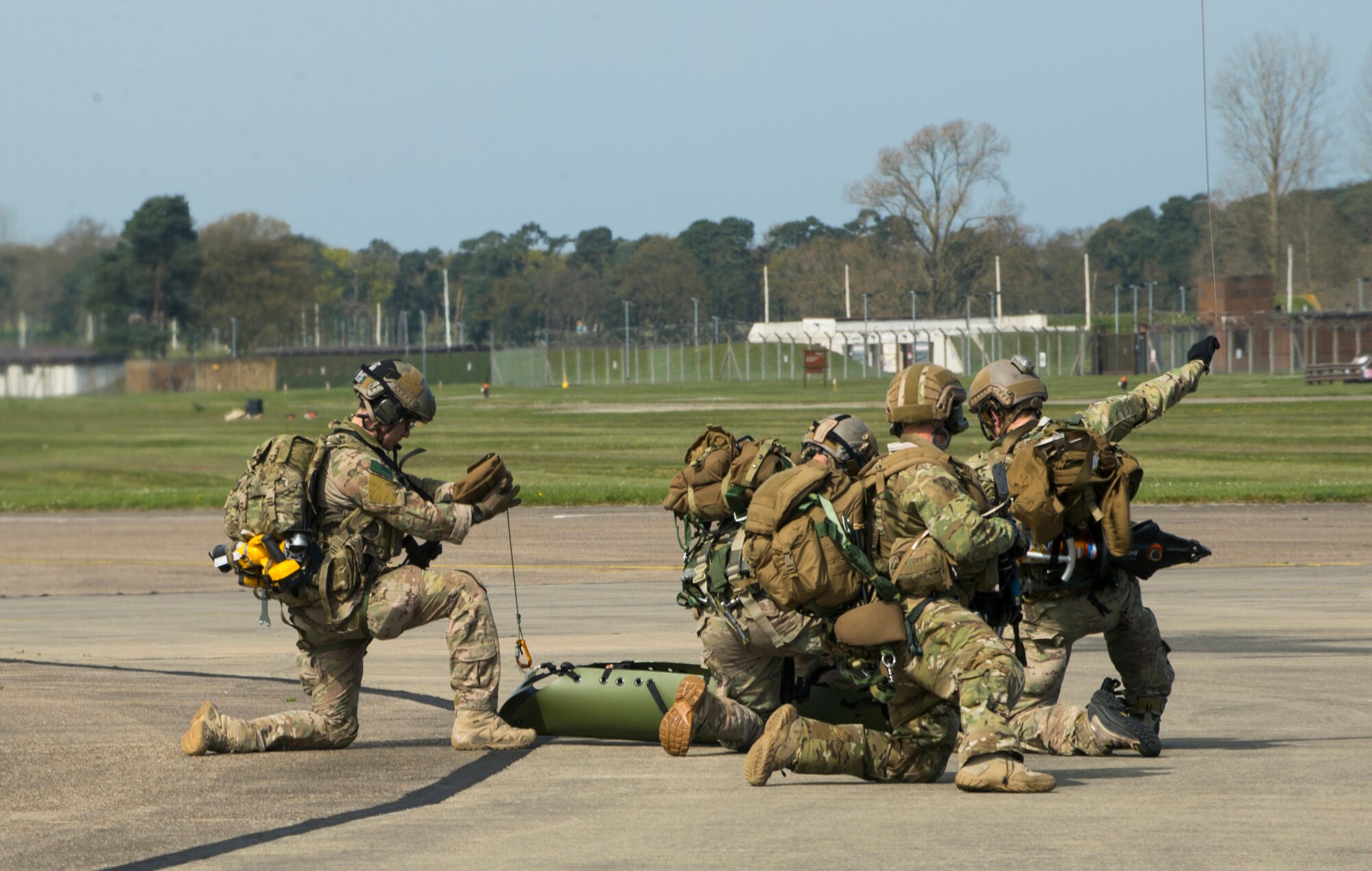 Pararescuemen assigned to the 57th Rescue Squadron begin to secure a mock crash scene victim onto a cargo hook before hoisting them up into an HH-60G Pave Hawk helicopter during a combat search and rescue demonstration at Royal Air Force Lakenheath, England, April 21, 2016. The demonstration simulated a victim trapped inside a vehicle while located in a high-threat environment. (U.S. Air Force photo/Staff Sgt. Emerson Nuñez)