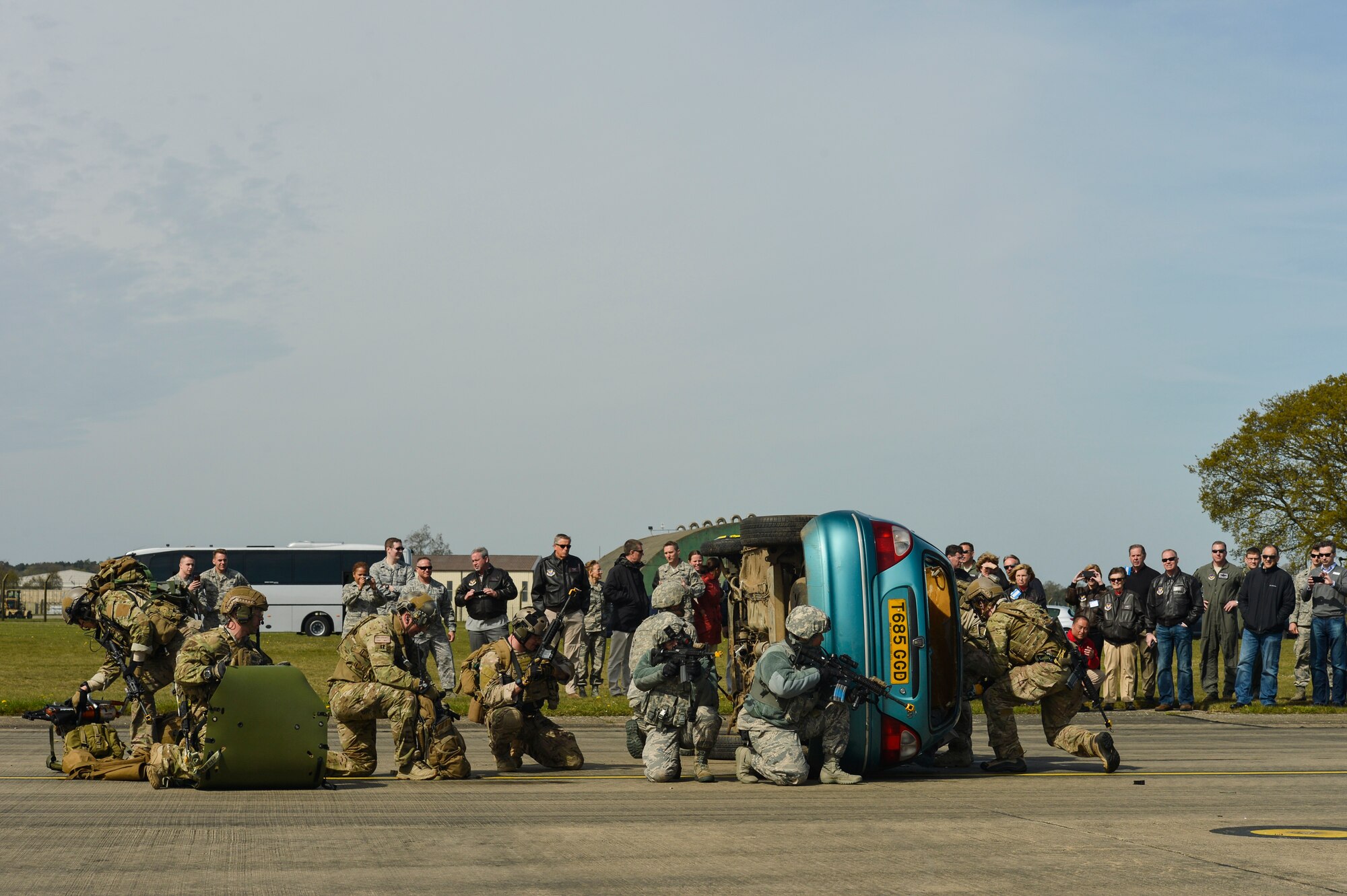 A group of U.S. Air Force pararescuemen with the 57th Rescue Squadron and 48th Security Forces Airmen conduct a combat search and rescue demonstration at Royal Air Force Lakenheath, England, for a group of Air Force civic leaders who act as key communicators and advocates for the Air Force, April 21, 2016. Pararescuemen performed various CSAR maneuvers to showcase their capabilities during a Chief of Staff of the  Air Force Civic Leader visit. (U.S. Air Force Photo by Tech. Sgt. Joshua DeMotts)