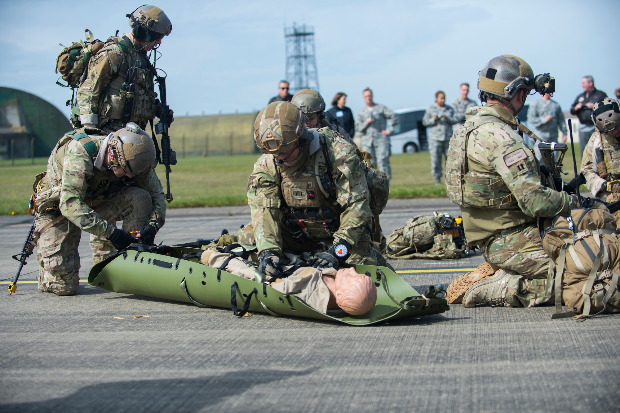 Pararescuemen assigned to the 57th Rescue Squadron secure a mock patient onto a litter during a combat search and rescue demonstration at Royal Air Force Lakenheath, England, April 21, 2016. The demonstration simulated a victim trapped in a vehicle while in a hostile environment. (U.S. Air Force photo/Staff Sgt. Emerson Nuñez)