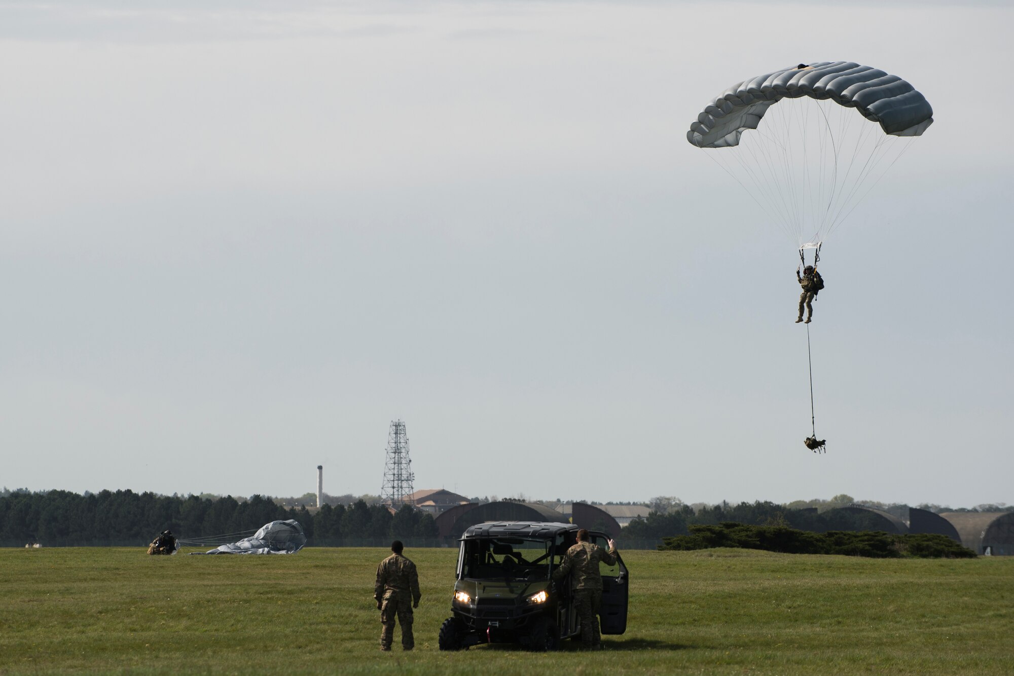 Pararescuemen assigned to the 57th Rescue Squadron, parachute onto the newly designated drop zone during a combat search and rescue demonstration at Royal Air Force Lakenheath, England, April 21, 2016. The pararescuemen showcased their new ability during a Chief of Staff of the Air Force Civic Leader visit to provide the members with better insight of mission capabilities. (U.S. Air Force photo/Staff Sgt. Emerson Nuñez)