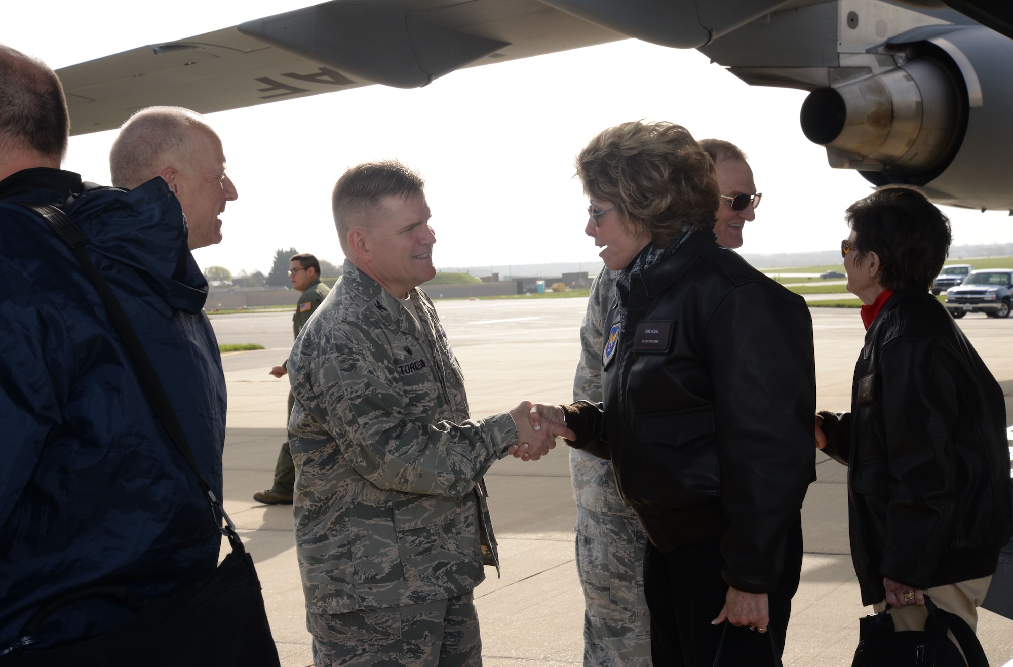 U.S. Air Force Col. Thomas D. Torkelson, 100th Air Refueling Wing commander, greets distinguished visitors as they exit an aircraft April 21, 2016, to begin the Air Force Civic Leader Program tour, at RAF Mildenhall, England. The guests are scheduled to visit the 100th Operation Support Squadron Air Traffic Control tower and the 100th Civil Engineering Squadron fire department, among other units. (U.S. Air Force photo by Senior Airman Justine Rho/Released)