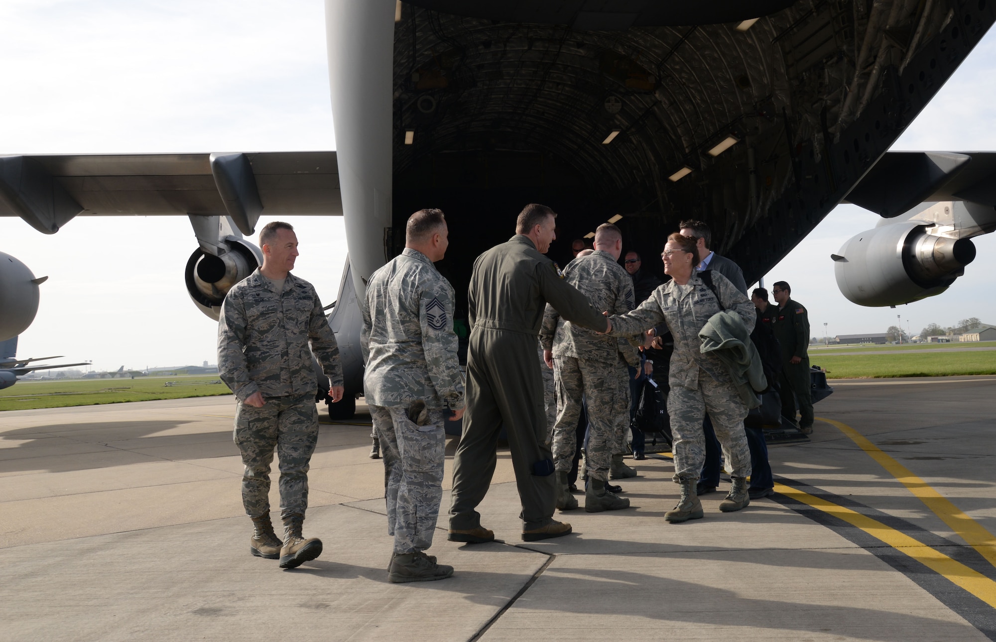 Base leadership from RAF Mildenhall and RAF Lakenheath, England shake hands with distinguished visitors arriving April 21, 2016, for the Air Force Civic Leader Program tour, at RAF Mildenhall, England. Civic leaders toured both bases to learn about their missions and to meet Airmen. (U.S. Air Force photo by Senior Airman Justine Rho/Released)