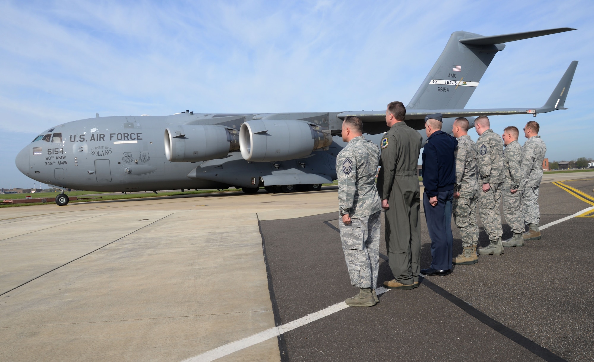 Leadership from RAF Mildenhall and RAF Lakenheath, England stand at attention to salute a U.S. Air Force C-17 Globemaster III from Travis Air Force Base, Calif., April 21, 2016, welcoming distinguished visitors to the United Kingdom. The civic leaders toured both bases to learn about their missions and to meet the Airmen. (U.S. Air Force photo by Senior Airman Justine Rho/Released)