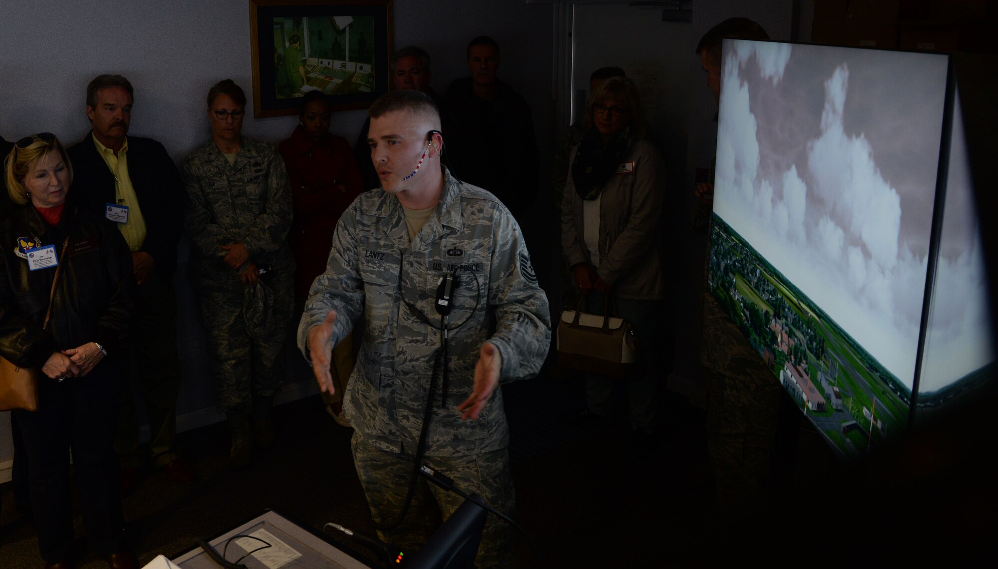 U.S. Air Force Tech. Sgt. Michael Lantz, 100th Operations Support Squadron Air Traffic Control watch supervisor, describes the capabilities of the ATC simulator to distinguished visitors April 22, 2016, during their tour of RAF Mildenhall, England. The ATC simulator allows those training to practice their skills in the best and most challenging settings. (U.S. Air Force photo by Senior Airman Justine Rho/Released)
