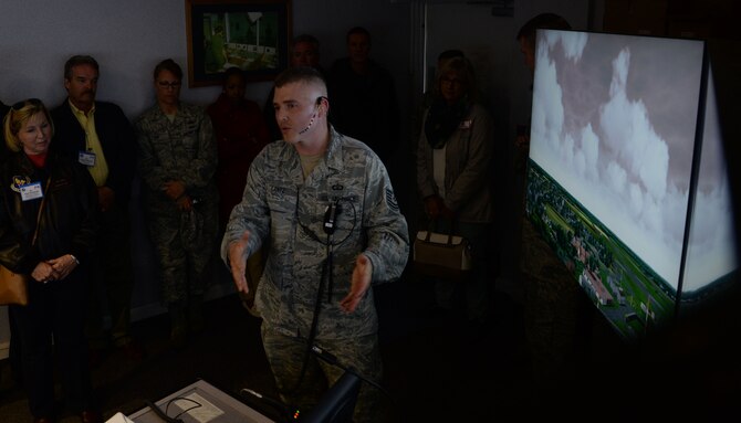 U.S. Air Force Tech. Sgt. Michael Lantz, 100th Operations Support Squadron Air Traffic Control watch supervisor, describes the capabilities of the ATC simulator to distinguished visitors April 22, 2016, during their tour of RAF Mildenhall, England. The ATC simulator allows those training to practice their skills in the best and most challenging settings. (U.S. Air Force photo by Senior Airman Justine Rho/Released)

