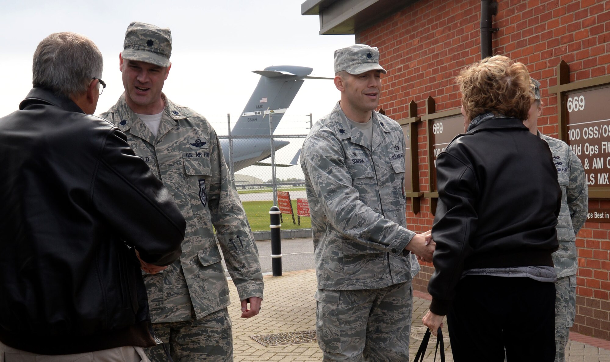 U.S. Air Force Lt. Col. Jay Butterfield, 100th Operations Support Squadron commander, left, and U.S. Air Force Lt. Col. Brandon Sokora, 100th Civil Engineering Squadron commander, greet civic leaders April 21, 2016, as they arrive at the 100th OSS Air Traffic Control tower on RAF Mildenhall, England. The attendees of the AF Civic Leader Program visited the ATC tower and the 100th CES fire department to learn about their mission and meet Airmen. (U.S. Air Force photo by Senior Airman Justine Rho/Released)