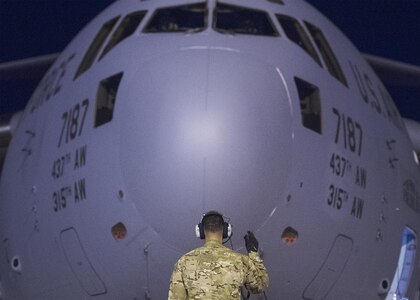 An Air Force crew chief prepares a C-17 that will transport Marine Corps Gen. Joe Dunford, chairman of the Joint Chiefs of Staff, on his departure from Iraq’s Kurdistan region, April 22, 2016. Dunford visited Iraq to assess the campaign against the Islamic State of Iraq and the Levant. DoD photo by Navy Petty Officer 2nd Class Dominique A. Pineiro