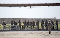 A Spanish soldier, a coalition trainer assigned to the Combined Joint Task Force - Operation Inherent Resolve, walks past Iraqi soldiers following training at Besmaya Range Complex, Iraq, April  21, 2016. DoD photo by Navy Petty Officer 2nd Class Dominique A. Pineiro