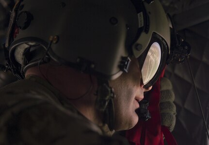 An Army aircrewman sits on the edge of a CH-47 Chinook helicopter during transit from Baghdad International Airport to Besmaya Range Complex, Iraq, April  21, 2016. DoD photo by Navy Petty Officer 2nd Class Dominique A. Pineiro