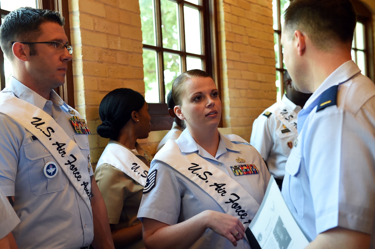Tech. Sgt. Jacqueline Crow, an intelligence analyst with the 149th Fighter Wing, Texas Air National Guard, and fellow Air Force ambassador, Tech. Sgt. Steven Nowicki, 341st Training Squadron, both headquartered at Joint Base San Antonio-Lackland, Texas, talk to 2nd Lt. Phil Fountain, a 149th Public Affairs officer, during the Fiesta 2016 Media Day, March 16, 2016, in downtown San Antonio. Crow and Nowicki represent JBSA as Air Force ambassadors, a military community engagement program that annually selects the top two members, male and female respectively, from each service branch as representatives. (U.S. Air National Guard photo by Staff Sgt. Mindy Bloem)
