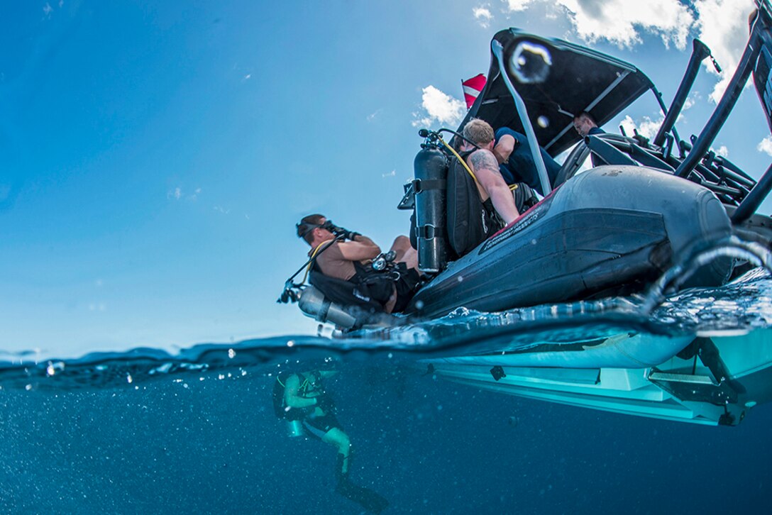 Navy Lt. Ryan Snow prepares to enter the water during a joint diving exercise with Sri Lanka navy personnel in the Apra Harbor off the coast of Guam, April 13, 2016. Snow, assigned to Explosive Ordnance Disposal Mobile Unit 5, dove to the Tokai Maru, a sunken WWII Japanese freighter. Navy photo by Petty Officer 3rd Class Alfred A. Coffield