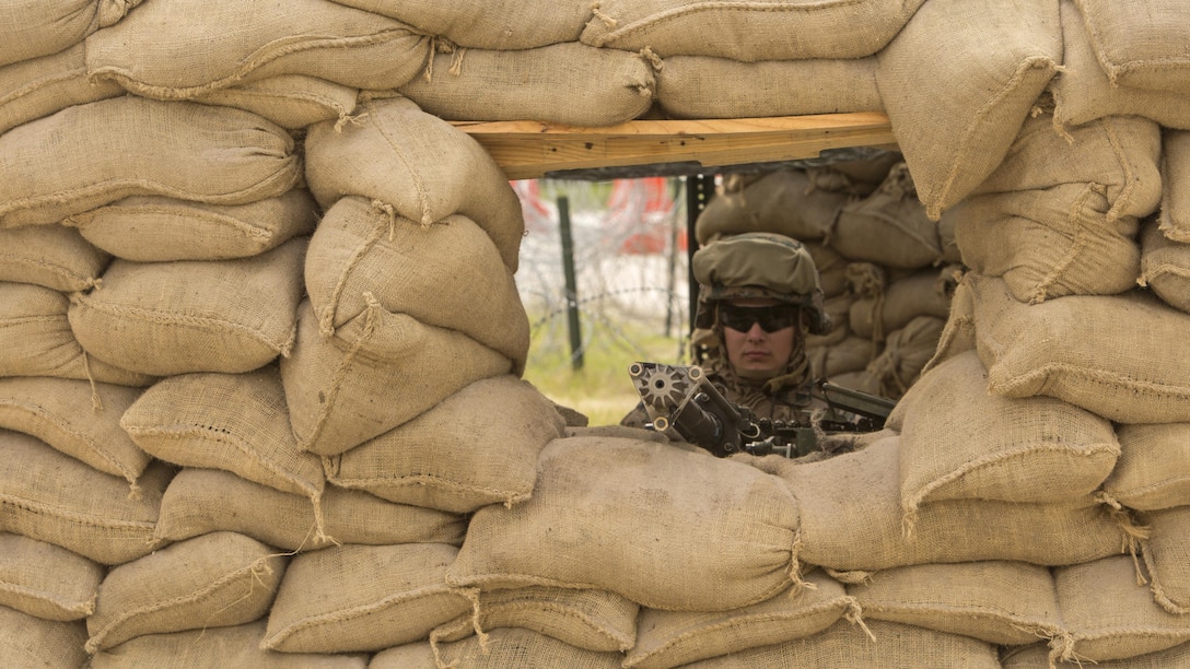 Cpl. Jacob Lebo, a rifleman with 1st Platoon, Bravo Company, 2nd Law Enforcement Battalion, mans the main security post built using over 600 sandbags with his .50 caliber machine gun during the II Marine Expeditionary Force Command Post Exercise 3 at Marine Corps Base Camp Lejeune, North Carolina, April 20, 2016. During the CPX, 2nd LEB posted security around the campsite and defend it from mock enemies, ensuring the headquarters element could complete the mission safely.