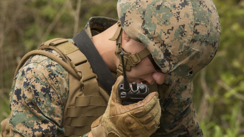 A fire team member with 1st Platoon, Bravo Company, 2nd Law Enforcement Battalion, calls in a report over the radio during a perimeter security patrol during the II Marine Expeditionary Force Command Post Exercise 3 at Marine Corps Base Camp Lejeune, North Carolina, April 20, 2016. During the CPX, 2nd LEB posted security around the campsite and defended it from mock enemies, ensuring the headquarters element could complete the mission safely.